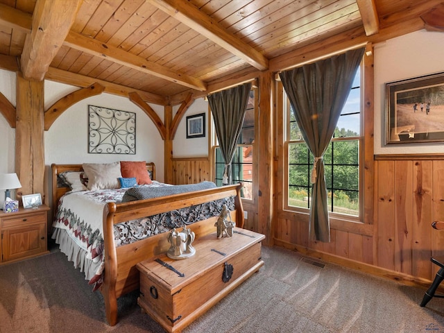 carpeted bedroom featuring beam ceiling, wood ceiling, and wooden walls