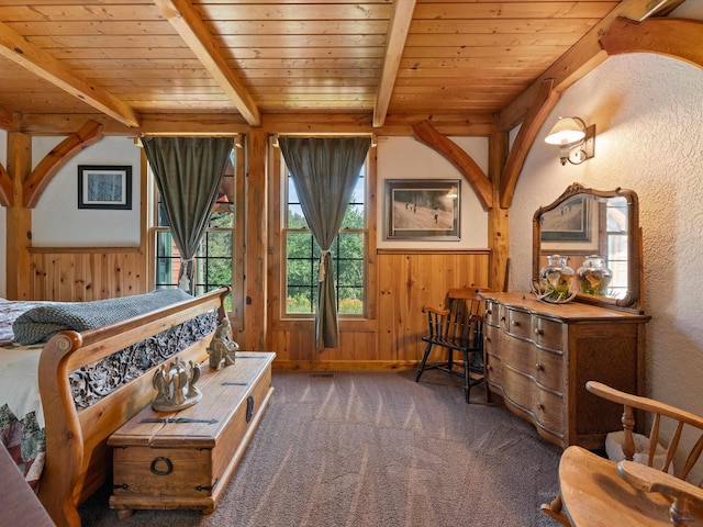 carpeted bedroom featuring wooden ceiling and beam ceiling