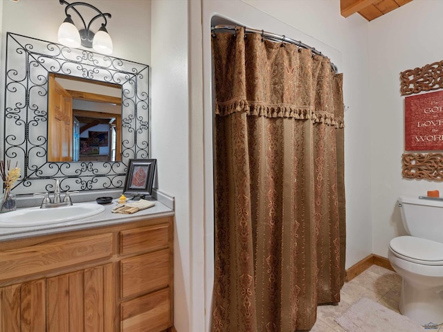 bathroom featuring vanity, tile patterned flooring, and toilet