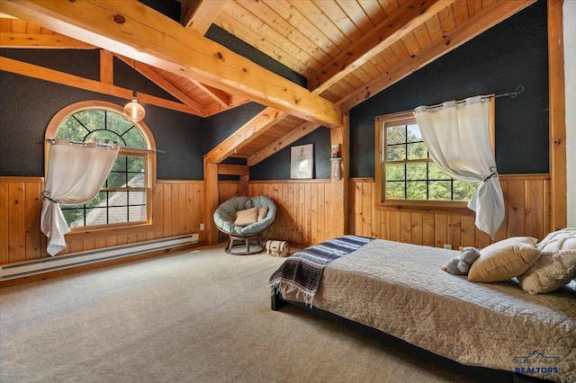 bedroom featuring a baseboard heating unit, vaulted ceiling with beams, and multiple windows