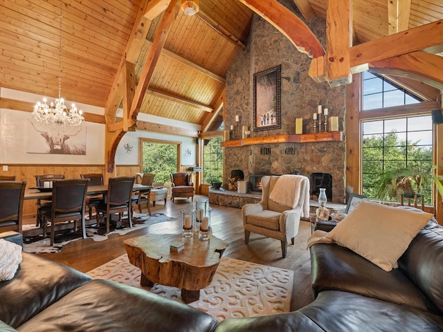 living room with plenty of natural light, a stone fireplace, wood ceiling, and hardwood / wood-style floors