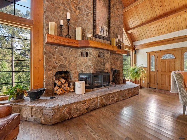 living room with a fireplace, hardwood / wood-style flooring, high vaulted ceiling, and wood ceiling