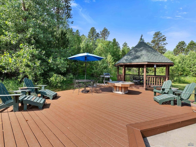 deck featuring a gazebo and an outdoor fire pit