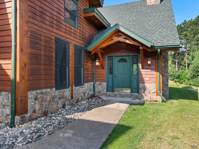 doorway to property featuring a lawn