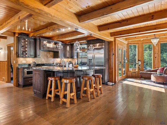 kitchen with wooden ceiling, beamed ceiling, dark hardwood / wood-style floors, dark brown cabinetry, and high end refrigerator