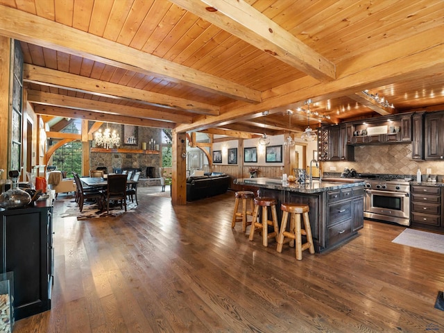 kitchen with dark brown cabinetry, high end stainless steel range oven, beam ceiling, and wood ceiling