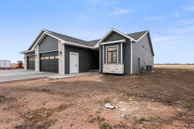 view of front of house with cooling unit and a garage