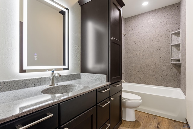 bathroom with shower / bathtub combination, vanity, toilet, and wood finished floors