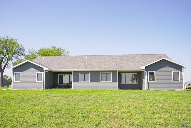 rear view of house with a yard