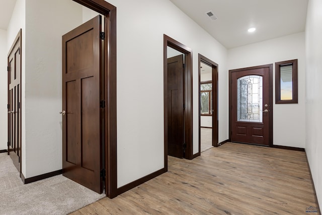 entrance foyer featuring light wood-type flooring, visible vents, baseboards, and recessed lighting