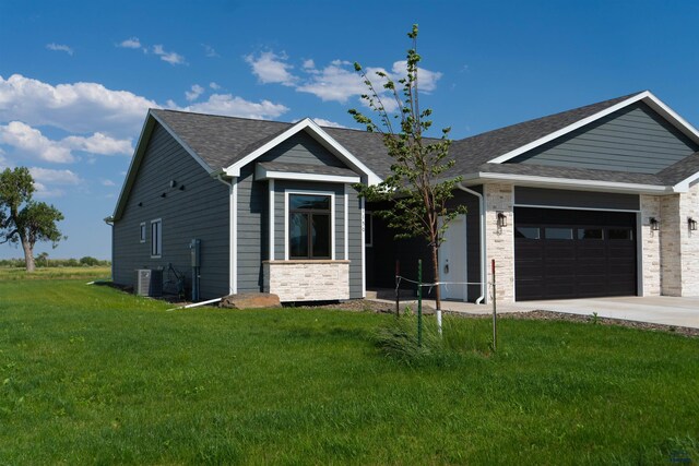 1150 Single Tree Dr Lot 23B, Piedmont, SD 57769 - ranch-style house with a garage, concrete driveway, a front yard, roof with shingles, and stone siding