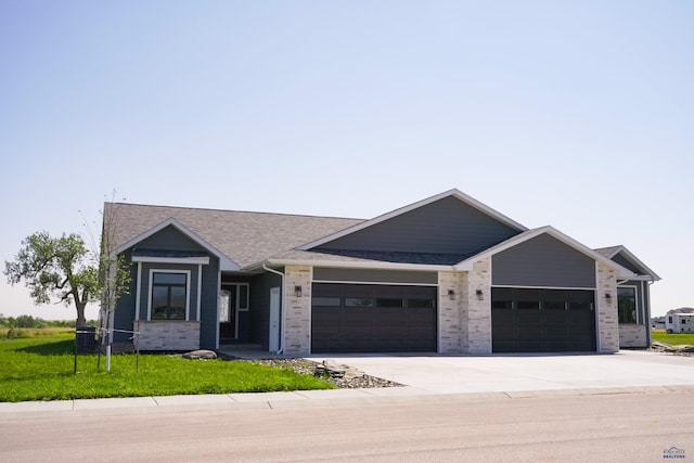 view of front of house with a shingled roof, brick siding, driveway, and an attached garage