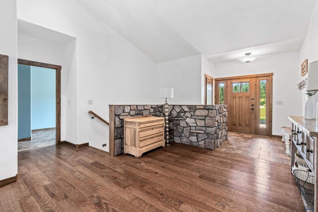 entryway with vaulted ceiling and dark wood-type flooring