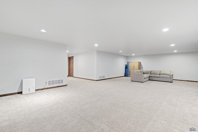 unfurnished living room featuring light colored carpet