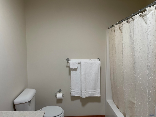 bathroom with shower / tub combo and toilet