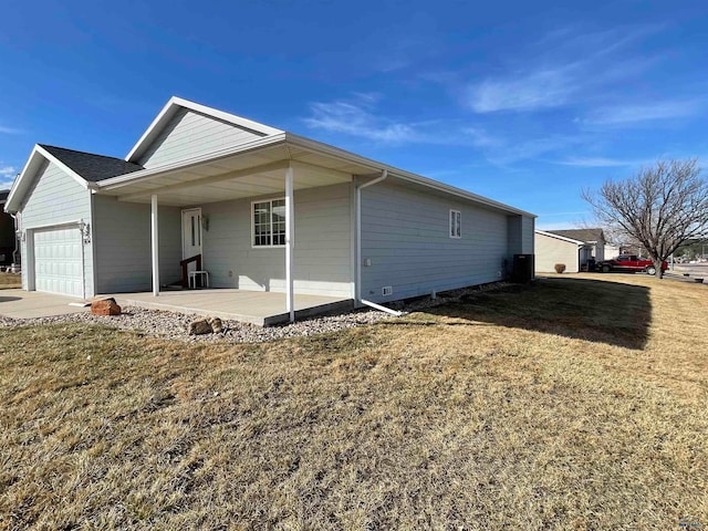 exterior space with a lawn, covered porch, and a garage