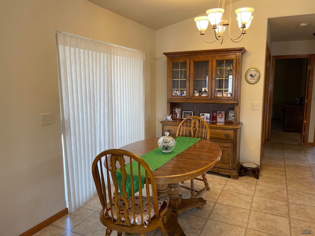 dining area featuring a notable chandelier and light tile patterned floors