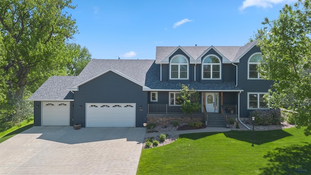 view of front of home featuring a garage and a front lawn