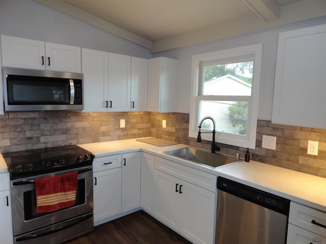 kitchen with stainless steel appliances, white cabinetry, and sink