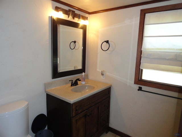 bathroom with vanity, toilet, and crown molding