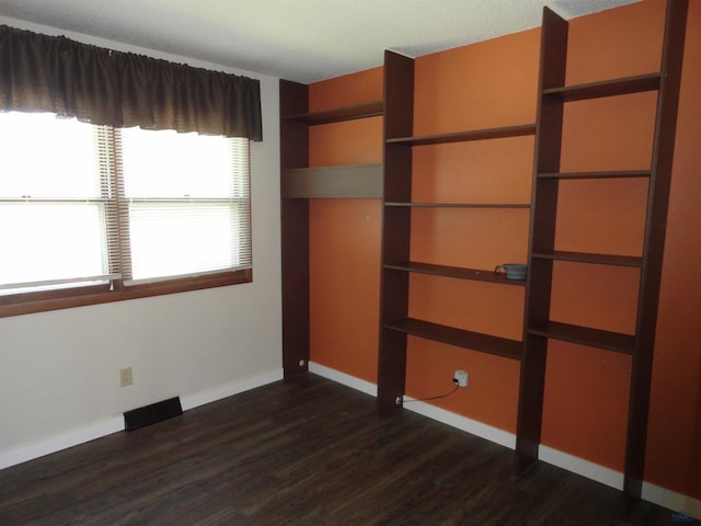 unfurnished bedroom featuring dark hardwood / wood-style flooring