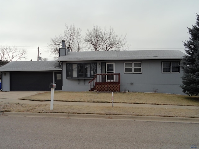 view of front of home with a garage and a front lawn