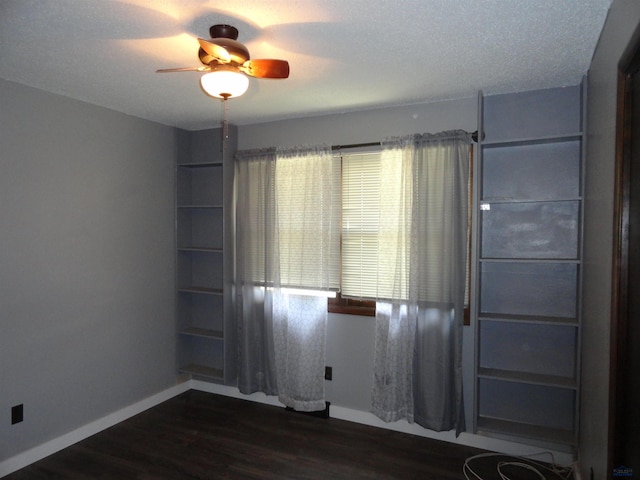 unfurnished room with dark hardwood / wood-style floors, ceiling fan, and a textured ceiling