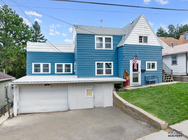 view of front facade with a garage and a front yard