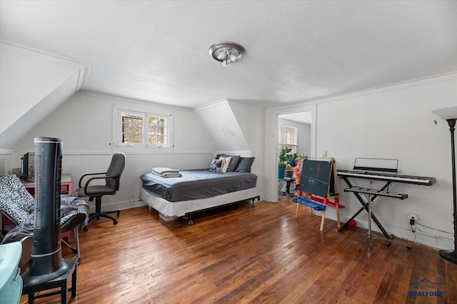 bedroom featuring a textured ceiling, lofted ceiling, and wood-type flooring