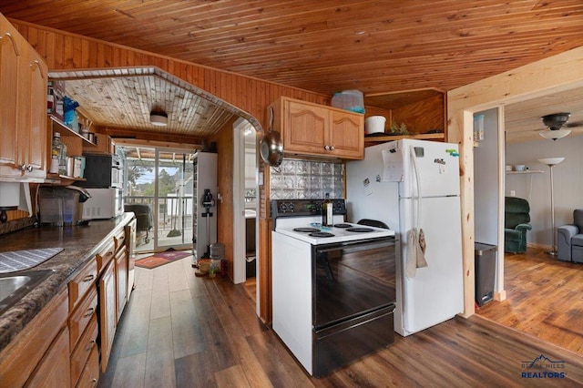 kitchen featuring wood walls, hardwood / wood-style floors, white appliances, and wood ceiling