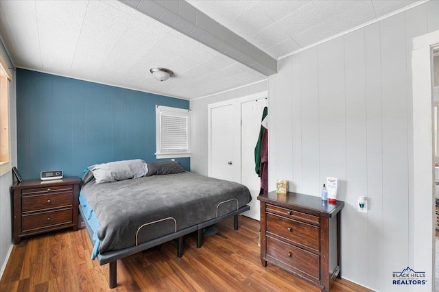 bedroom with hardwood / wood-style flooring