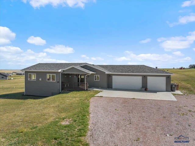 ranch-style home with roof with shingles, a porch, an attached garage, a front yard, and driveway