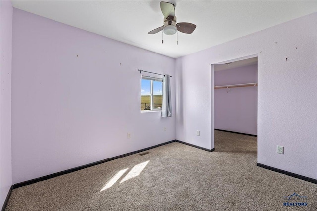 unfurnished bedroom featuring baseboards, visible vents, light colored carpet, ceiling fan, and a closet