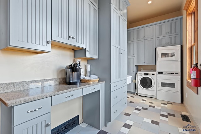 washroom featuring light tile patterned floors, washer and dryer, and stacked washer and dryer