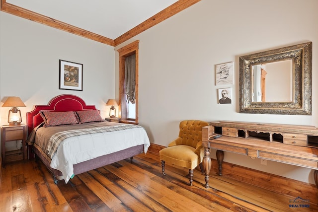 bedroom featuring crown molding and dark hardwood / wood-style floors