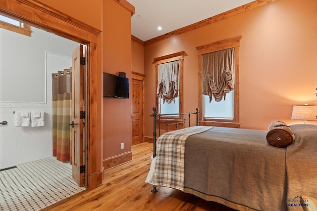 bedroom featuring ornamental molding and light wood-type flooring