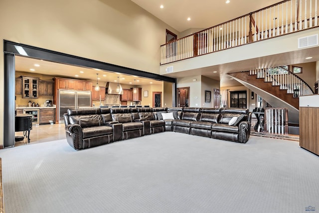 living room featuring light tile patterned flooring, beverage cooler, and a high ceiling