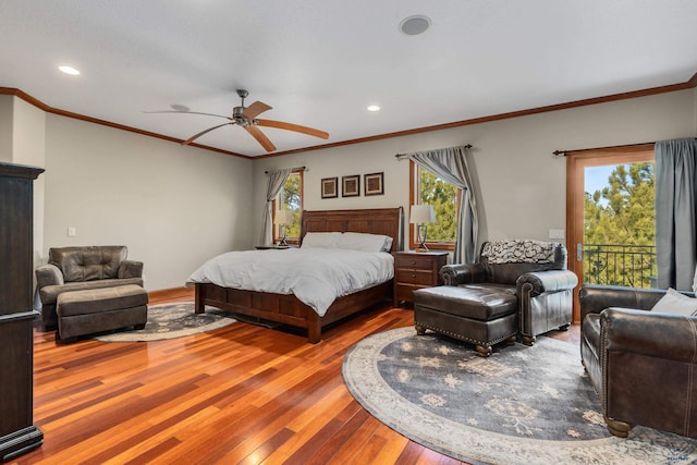 bedroom featuring hardwood / wood-style floors, ornamental molding, ceiling fan, and multiple windows