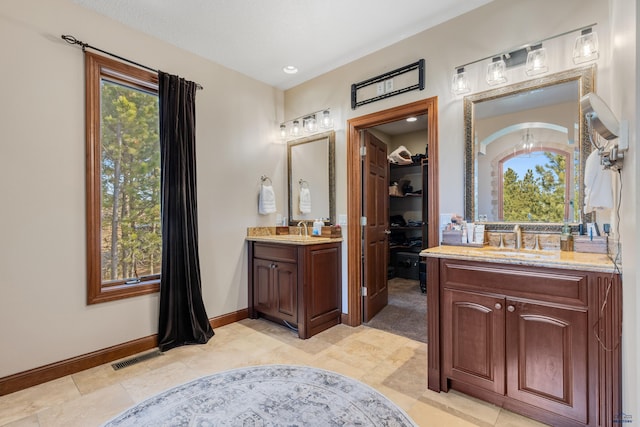 bathroom with plenty of natural light, vanity, and tile patterned floors