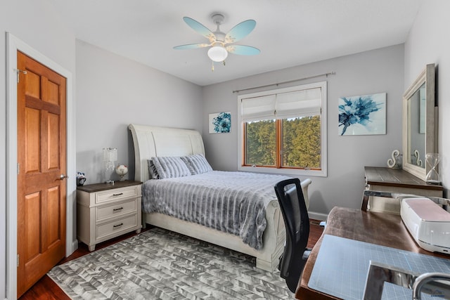 bedroom with ceiling fan and dark hardwood / wood-style flooring