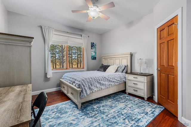 bedroom with ceiling fan and dark hardwood / wood-style floors