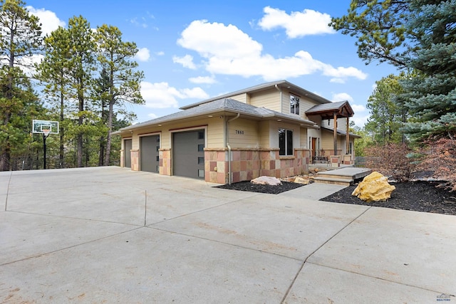 view of property exterior with a garage and an outbuilding