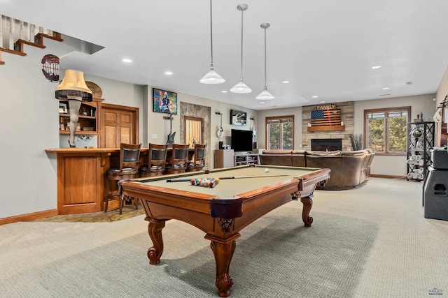 playroom featuring a stone fireplace, pool table, and light colored carpet