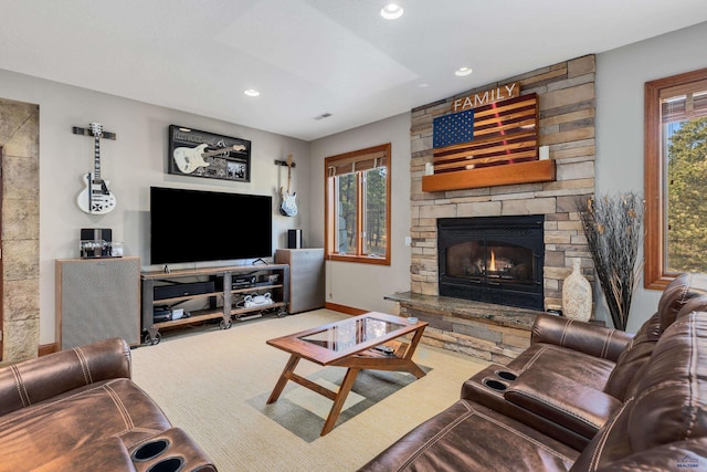 living room featuring carpet, a fireplace, and a healthy amount of sunlight