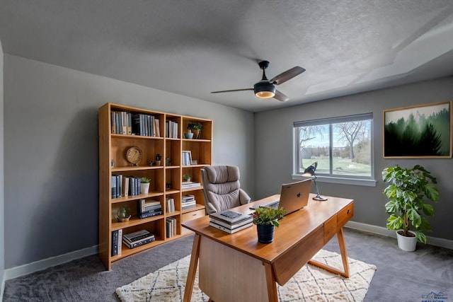 office with a textured ceiling, carpet flooring, and ceiling fan