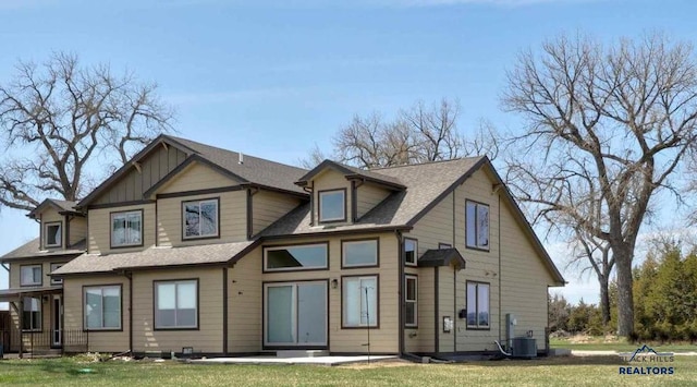 view of front of house featuring cooling unit and a front yard