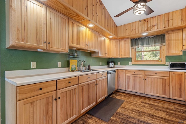 kitchen featuring ceiling fan, dark hardwood / wood-style floors, dishwasher, sink, and lofted ceiling