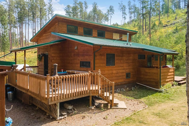 rear view of property featuring a deck