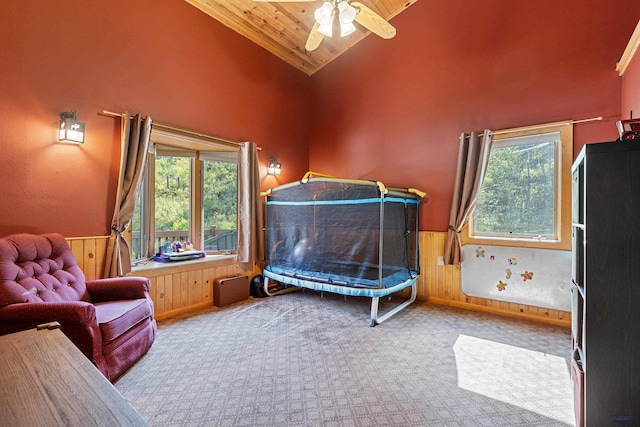 carpeted bedroom featuring wooden ceiling, high vaulted ceiling, and ceiling fan