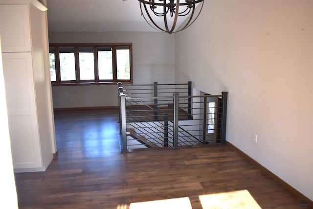 stairs featuring a notable chandelier and hardwood / wood-style floors